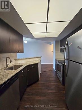 Toronto (Bay Street Corridor) condo for rent - A kitchen with a refrigerator, sink, and cabinets.