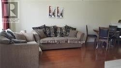 Mississauga (Hurontario) apartment for rent - A living room with a couch and a chair.