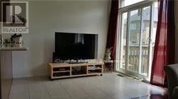 Mississauga (Hurontario) apartment for rent - A living room with a flat screen TV on a wooden stand.
