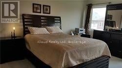 Mississauga (Hurontario) apartment for rent - A bedroom with a bed, nightstand, and a mirror.