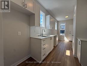 Ottawa townhouse for rent - A kitchen with white cabinets and a window.