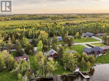 Kawartha Lakes (Eldon) apartment for rent - An aerial view of a residential area with houses and a body of water.