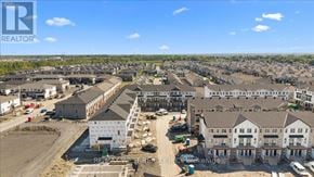 Ottawa townhouse for rent - A real estate company is showcasing a housing development with multiple buildings under construction.