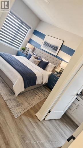 Niagara Falls (Forestview) apartment for rent - A bedroom with a bed, a mirror, and a cabinet.