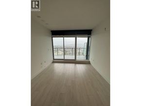 Burnaby apartment for rent - A room with wooden flooring and a large window with a view of the city.