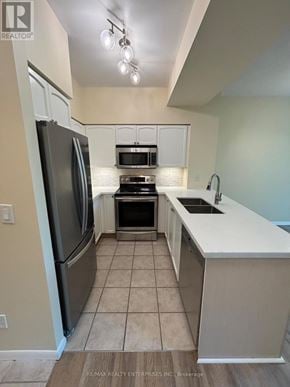 Toronto (Niagara) condo for rent - A kitchen with a refrigerator, microwave, oven, and sink.
