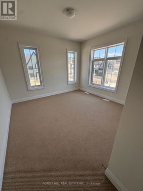Oro-Medonte (Horseshoe Valley) apartment for rent - A room with carpet flooring and two windows.