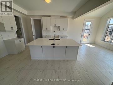 Oro-Medonte (Horseshoe Valley) apartment for rent - A kitchen with white cabinets and a large island in the middle.