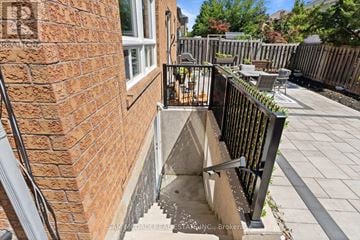 Milton (Cl Clarke) apartment for rent - A brick wall with a black railing and a small concrete staircase.