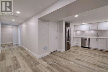 Toronto (Princess-Rosethorn) apartment for rent - A kitchen with white cabinets and a refrigerator.