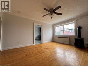 Kitchener apartment for rent - A room with a ceiling fan and a window with a view of a building outside.