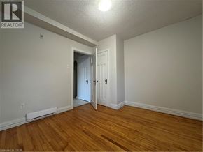 Kitchener apartment for rent - A room with wood flooring and white walls.