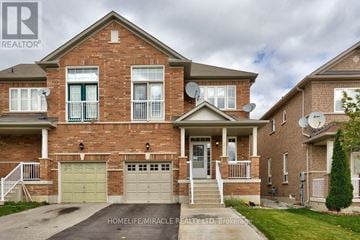 Brampton (Bram West) apartment for rent - A brick house with a garage and a front porch.