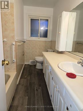 St. Catharines (Oakdale) apartment for rent - A bathroom with a toilet in the corner.