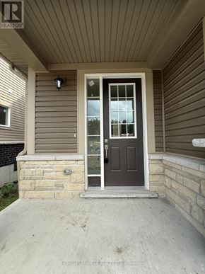 Loyalist (Bath) apartment for rent - A house with a brown door and a stone pillar.