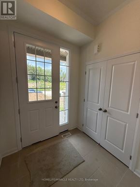 Loyalist (Bath) apartment for rent - A room with white doors and a window with a view of a parking lot.