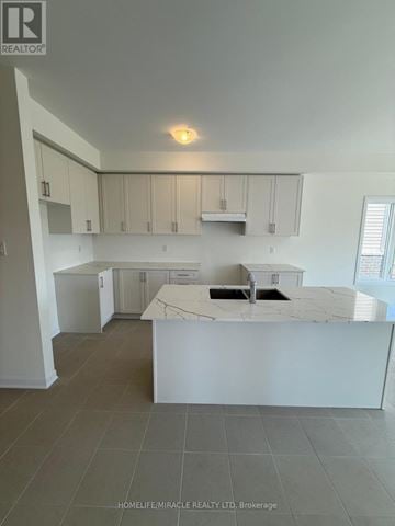 Loyalist (Bath) apartment for rent - A kitchen with white cabinets and a marble countertop.