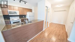 Toronto (Waterfront Communities) condo for rent - A kitchen with a refrigerator, sink, and stove.