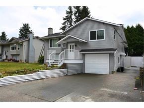 Surrey apartment for rent - A grey house with a white garage door and a grey roof.
