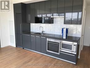 Toronto (Bayview Village) condo for rent - A kitchen with a black counter top and stainless steel appliances.