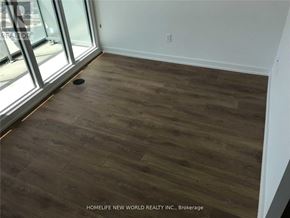 Toronto (Bayview Village) condo for rent - A room with wooden flooring and a large window.