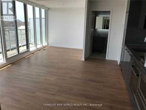 Toronto (Bayview Village) condo for rent - A room with wooden flooring and a large window.