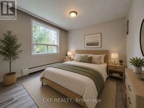 Toronto (Mimico) multi-family for rent - A bedroom with a bed, nightstand, and a plant.