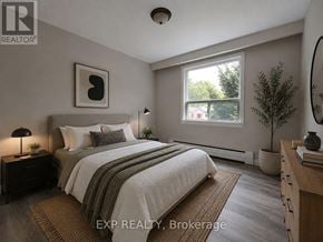 Toronto (Mimico) multi-family for rent - A bedroom with a bed, nightstand, and window.