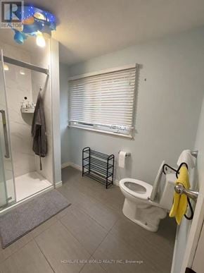 Mississauga (Erin Mills) apartment for rent - A bathroom with a toilet, a glass shower door, and a towel rack.