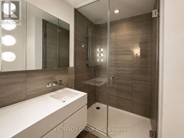 Toronto (Church-Yonge Corridor) condo for rent - A modern bathroom with a sink, mirror, and shower.