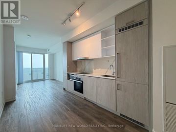 Toronto (Waterfront Communities) condo for rent - A spacious kitchen with wooden cabinets and a large island.