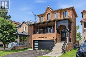 Mississauga (Meadowvale Village) apartment for rent - A large brick house with a balcony and a black gate.