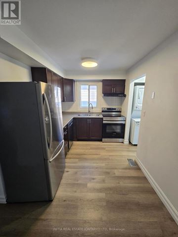 London North (North I) apartment for rent - A kitchen with a refrigerator, oven, and sink.