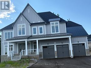 Oro-Medonte apartment for rent - A large house with a grey roof and a black garage door.