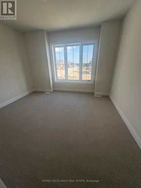 Oro-Medonte apartment for rent - A room with a carpeted floor and a window overlooking a parking lot.