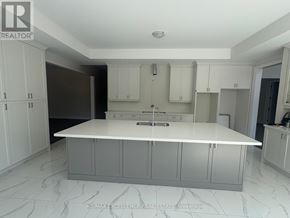 Oro-Medonte apartment for rent - A white kitchen with a marble floor and white cabinets.