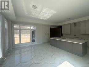 Oro-Medonte apartment for rent - A spacious kitchen with marble flooring and a large island.