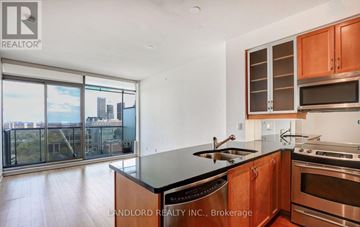 Toronto (Annex) condo for rent - A modern kitchen with wooden cabinets and stainless steel appliances.