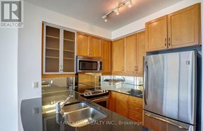 Toronto (Annex) condo for rent - A kitchen with wooden cabinets and stainless steel appliances.