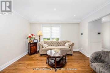Toronto (Newtonbrook East) apartment for rent - A well-lit living room with a grey sofa and a wooden coffee table.