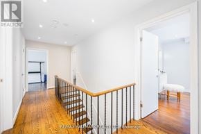 Toronto (Newtonbrook East) apartment for rent - A hallway with a wooden floor and a staircase with a metal railing.