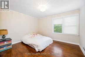 Toronto (Newtonbrook East) apartment for rent - A bedroom with a bed, a lamp, and a window.