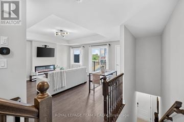 Ottawa townhouse for rent - A living room with a white couch and a television on the wall.