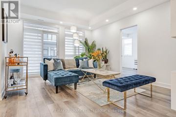 Ottawa condo for rent - A living room with a blue couch and a gold side table.