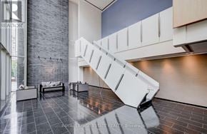Toronto (Church-Yonge Corridor) condo for rent - A modern living room with a staircase and a grey wall.