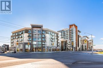 Hamilton (Waterdown) condo for rent - A street view of a residential area with modern buildings and a clear sky.