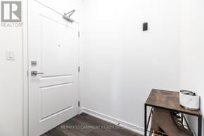 Hamilton (Waterdown) condo for rent - A white door with a black handle and a toaster on a table.