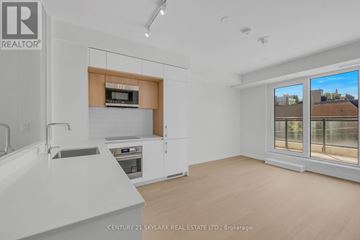 Toronto (Annex) condo for rent - A modern kitchen with white cabinets and a wooden accent on the countertop.