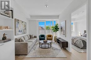 Toronto (Annex) condo for rent - A well-lit, modern living room with a large window and a view of the sky.