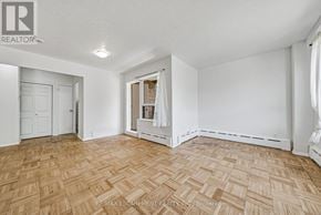Hamilton (Durand) condo for rent - A room with a wooden floor and white walls.